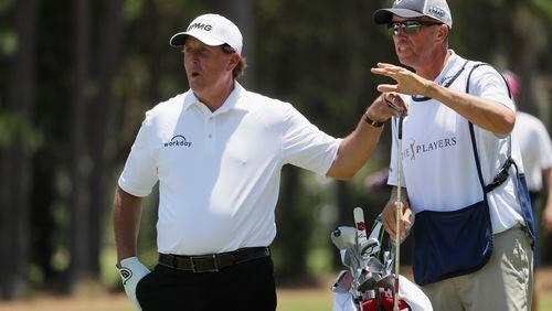 Phil Mickelson and his left-hand man, caddie Jim Mackay, plot a shot at this year's Players Championship.(Jamie Squire/Getty Images)