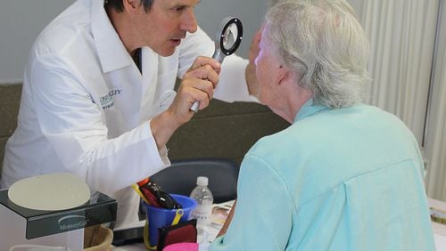 Dr Thomas Rak performs a health screening for skin cancer. Northside Hospital’s Cancer Institute in Sandy Springs is conducting free screenings on May 18.