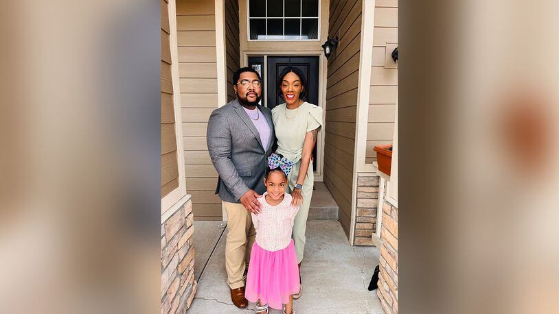 In a recent photo Qualin Campbell stands with his wife Talija and their younger daughter, age 4. Campbell was shot and killed June 2, 2023, in Colorado Springs. His family says police were called when he was taken hostage but didn't respond for an hour, after Campbell was dead.