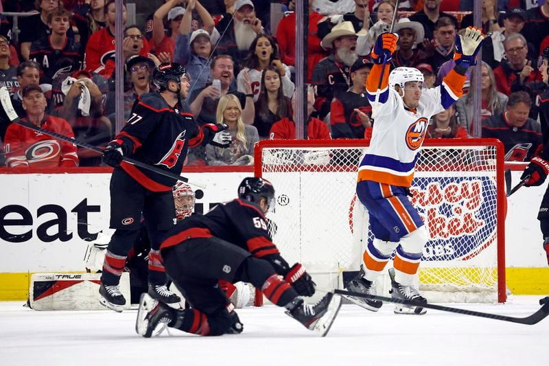 New York Islanders' Bo Horvat (14) celebrates a goal by teammate Casey Cizikas, not pictured, during the second period in Game 5 of an NHL hockey Stanley Cup first-round playoff series against the Carolina Hurricanes in Raleigh, N.C., Tuesday, April 30, 2024. (AP Photo/Karl B DeBlaker)