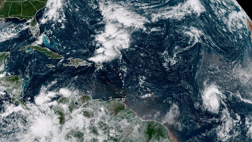 A satellite photo provided by the National Oceanographic and Atmospheric Administration shows Tropical Storm Sam, lower right, on Thursday. Sam is the 18th named storm of a busy 2021 hurricane season, and the fourth to form in less than a week.