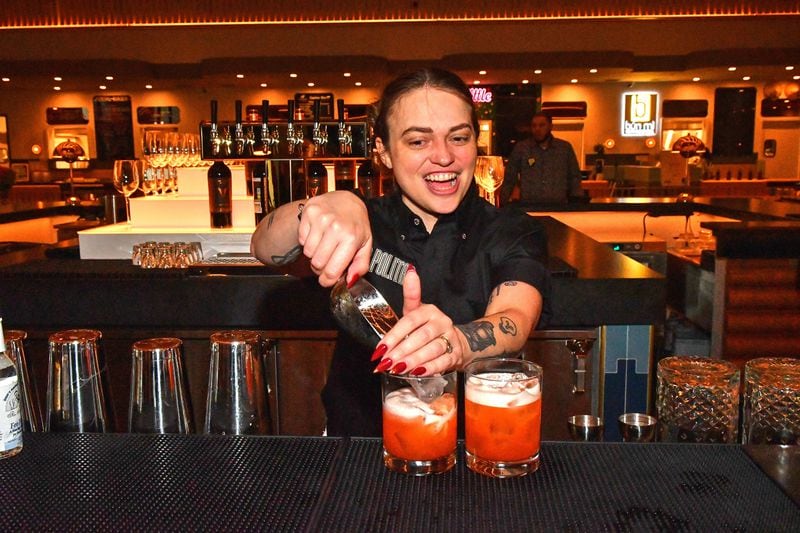 Beverage director Sophie Burton puts the final touches on a couple of drinks at the centrally located bar in the new Politan Row at Colony Square in Atlanta. (Chris Hunt for The Atlanta Journal-Constitution)
