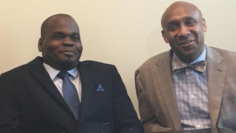 Basil Eleby, at left, faced felony charges in the I-85 bridge collapse, but is now working at Davis Bozeman law firm in Decatur. At right is his lawyer Mawuli Davis, one of the attorneys who represented him at no charge.