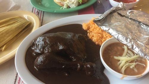 The chicken mole is a wonderful way to sample the traditional Oaxacan fare at Taqueria La Oaxaqueña in Jonesboro. Above left: a tamale with pork and green salsa and a sope with lengua. CONTRIBUTED BY WENDELL BROCK