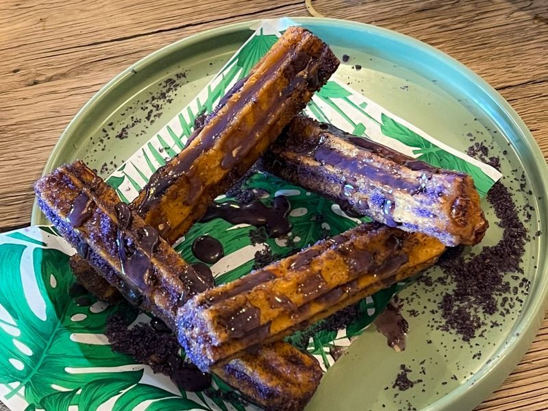 All of Kamayan's desserts are appealing, but the freshly fried ube churros are a must-try. Henri Hollis/henri.hollis@ajc.com
