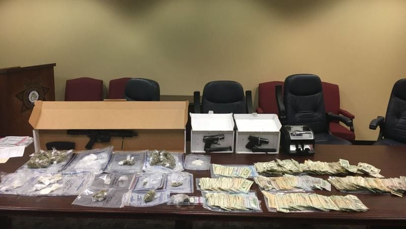 Authorities said they discovered four ounces of cocaine, 14 ounces of marijuana, ecstasy, three stolen guns and $21,000 cash while searching the Atlanta condo. 