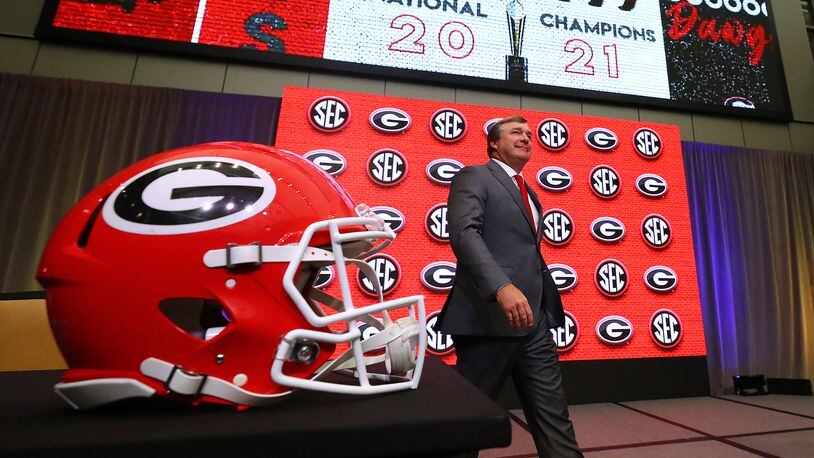 Georgia head coach Kirby Smart takes the stage for his press conference at SEC Media Days with 2021 National Champions flashing on the screen in the College Football Hall of Fame on Wednesday, July 20, 2022, in Atlanta.   (Curtis Compton / Curtis Compton@ajc.com)