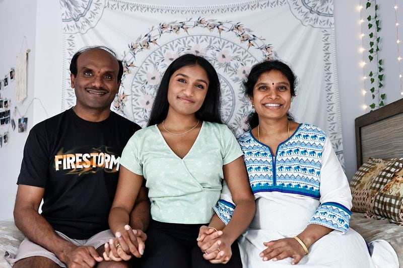 Lakshmi Potturu, 17 (center) pictured with her mother and father. Although she moved to The U.S. with her family when she was two, her legal status is based upon her father’s temporary work visa. (Natrice Miller/natrice.miller@ajc.com)