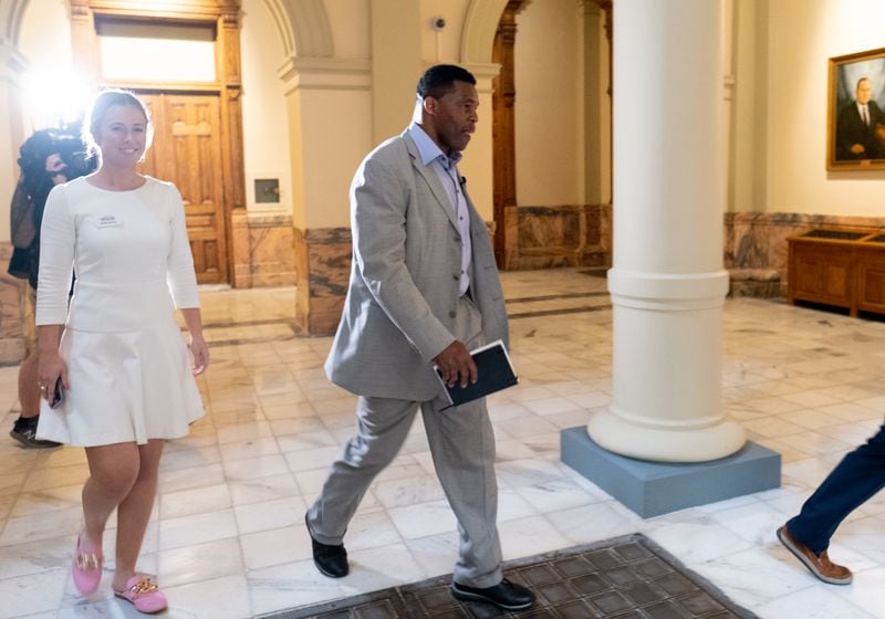 Herschel Walker arrives at the Georgia State Capitol to qualify to run for U.S. Senate on Monday. Walker and various business partners have defaulted or fell behind in payments on at least eight loans totaling $9 million over the past two decades, according to an AJC review of hundreds of pages of documents. (Ben Gray for the Atlanta Journal-Constitution)