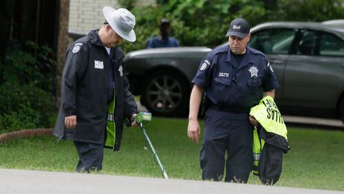 Dallas County Sheriff crime scene investigators use a metal detector at the intersection near where Jordan Edwards was killed by a police officer in Balch Springs, Texas, Wednesday, May 3, 2017. (AP Photo/LM Otero)