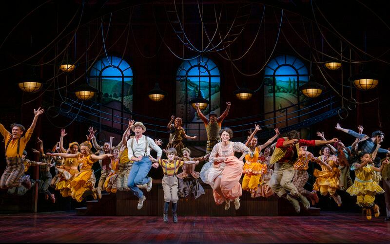 Hugh Jackman and Sutton Foster kick it up in "The Music Man" on Broadway, with Atlantan Shuler Hensley raising his arms high behind Foster. (Photo by Joan Marcus)