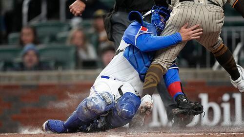 San Diego Padres' Rougned Odor (24) collides with Atlanta Braves catcher Travis d'Arnaud (16) during the fourth inning of a baseball game Saturday, April 8, 2023, in Atlanta. (AP Photo/John Bazemore)