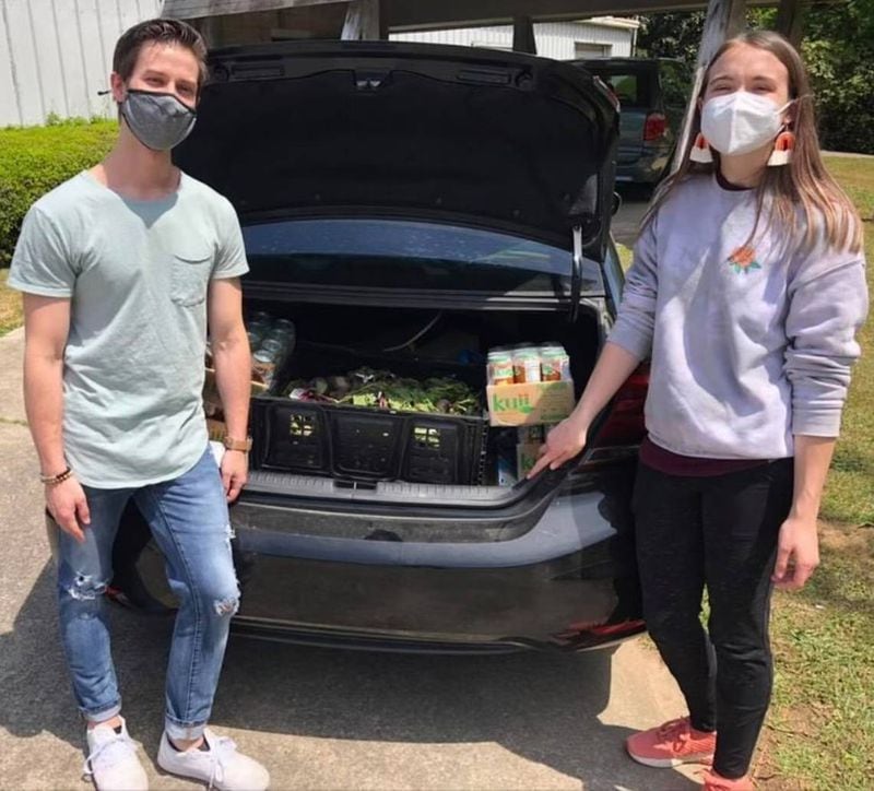 Leonard Oxley, left, and Hannah Matthews, co-founders of Macon Community Fridge, make a grocery run to stock the fridge during the COVID-19 pandemic. (Photo Courtesy of Macon Community Fridge)