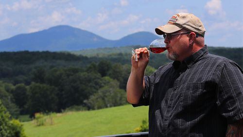 Local resident James Redden, 45, takes in the view of the Appalachian Mountains while tasting wine on the back porch at Kaya Vineyard & Winery in Dahlonega.