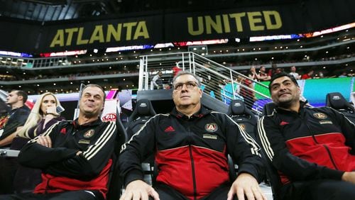 In this file photo Atlanta United coach Gerardo 'Tata 'Martino watches his team fromthe bench with his coaching staff.