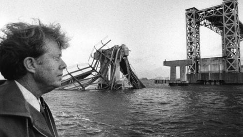 Georgia Gov. Jimmy Carter examines the damage left behind at Sidney Lanier Bridge in 1972 after a deadly collision by an 11,000-ton cargo ship at the Brunswick waterway. (AJC file photo)