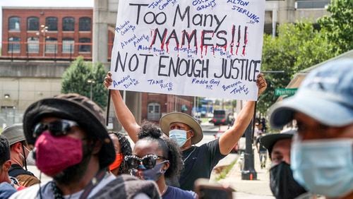 Demonstrators carry signs as they rally outside of the Atlanta City Detention Center, on Sunday, June 14, 2020, to protest against the recent police shooting of Rayshard Brooks, a 27-year-old Black man, who was shot and killed by Atlanta police Friday evening during a struggle in a Wendy's drive-thru line.     Alyssa Pointer / alyssa.pointer@ajc.com
