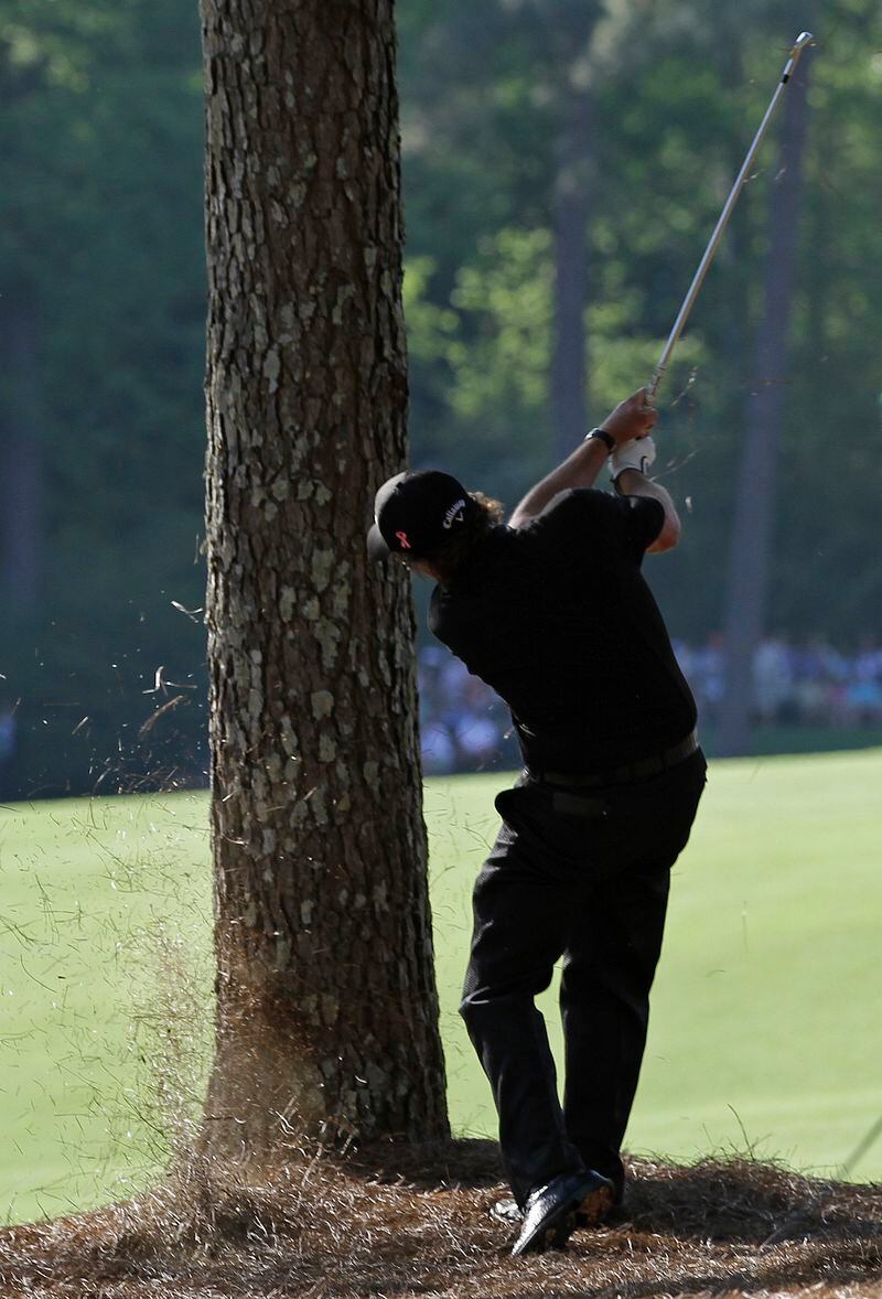  Phil Mickelson defies the odds and goes for it on No. 13 during the final round of the 2010 Masters. (AP Photo/Rob Carr)