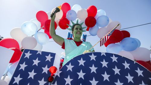Cathy Smith was the state of liberty on the Avonlea Apartments float. Hundreds of spectators lined the streets of Marietta Tuesday, July 4, 2017 for the Marietta Freedom Parade.