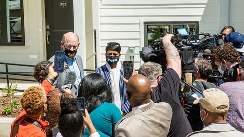Mayor Keisha Lance Bottoms, center, takes reporter questions after the formal ribbon cutting at Home on The Westside housing complex built for long-time Westside residents who need affordable housing Wednesday, April 21, 2021.  (Jenni Girtman for The Atlanta Journal-Constitution)