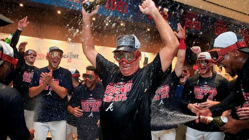 Braves manager Brian Snitker takes a deep dive in the celebration of a division championship. (Daniel Shirey/Getty Images)
