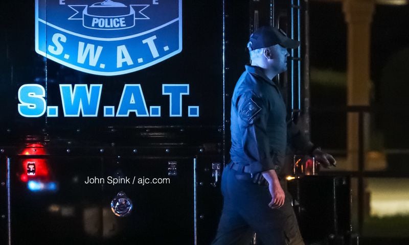 DeKalb County SWAT responded to the Knights Inn motel on Lawrenceville Highway. The motel was evacuated and the road was closed during an hours-long standoff. JOHN SPINK / JSPINK@AJC.COM
