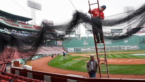 Local 7 ironworkers Kevin McConologue (on ladder) and Scott White (below) put protective netting in place over the seating behind home plate at Fenway Park in Boston Thursday, April 2, 2009 as preparations are underway for Monday's Boston Red Sox home opener against the Tampa Bay Rays. (AP Photo/Elise Amendola)