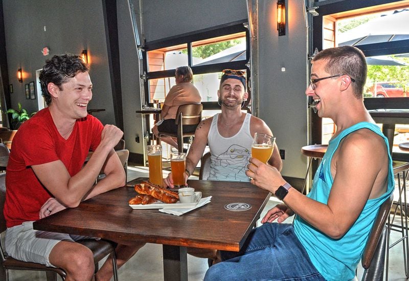 Alex Rhinehart, Eric Laska and Nick Jones enjoy beer and fresh-made Tavern Pretzels at the Lost Druid.