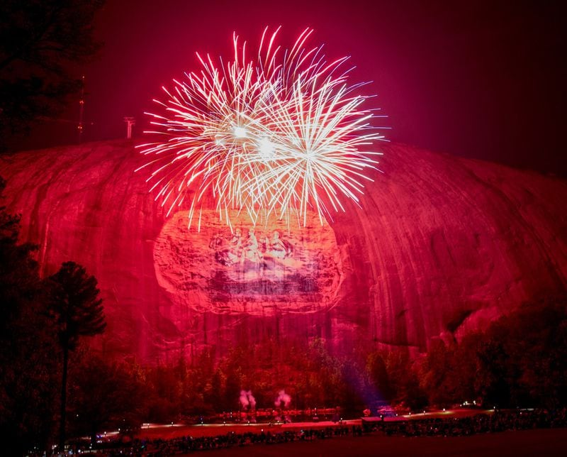 Fireworks explode during the laser show at Stone Mountain Park. STEVE SCHAEFER / SPECIAL TO THE AJC