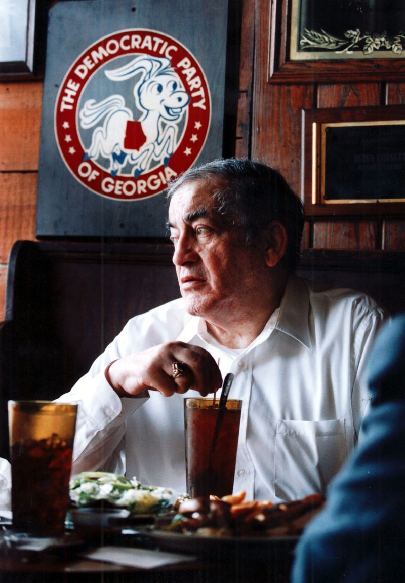Former DeKalb County CEO Manuel Maloof looks out from his favorite booth at his tavern on North Highland Avenue in 1993. (John Spink/AJC staff)