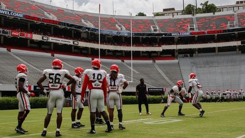 Georgia defensive football players gather for drills at practice Saturday, Aug., 18, 2018, at Sanford Stadium in Athens.