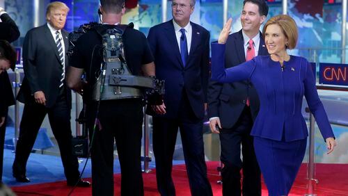Republican presidential candidate, businesswoman Carly Fiorina, right, leads fellow candidates Scott Walker, second from right, Jeb Bush, center, and Donald Trump as they take the stage prior to the CNN Republican presidential debate at the Ronald Reagan Presidential Library and Museum on Wednesday, Sept. 16, 2015, in Simi Valley, Calif. (AP Photo/Chris Carlson)