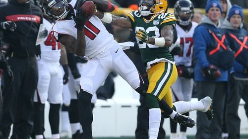 Julio Jones of the Atlanta Falcons catches a pass in front of Jaire Alexander of the Green Bay Packers during the first half of a game at Lambeau Field on December 09, 2018 in Green Bay, Wisconsin. (Photo by Dylan Buell/Getty Images)