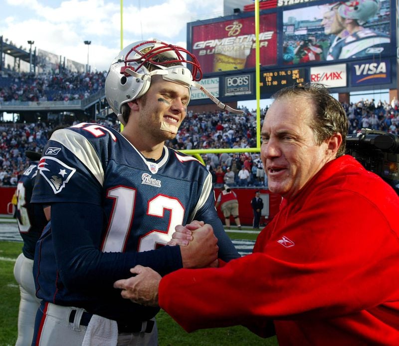 New England Patriots head coach Bill Belichick congratulates quarterback Tom Brady after the Patriots won their 19th game in a row, a 24-10 win over the Miami Dolphins at Gillette Stadium in Foxboro, Mass. Sunday, Oct. 10, 2004. (AP Photo/Winslow Townson)