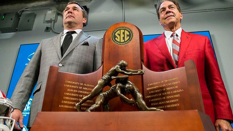 11/30/2018 -- Atlanta, Georgia -- University of Georgia head football coach Kirby Smart (left) and University of Alabama head coach Nick Saban (right) stand for a photo with the SEC Championship trophy during a press conference at Mercedes Benz Stadium, Friday, November 30, 2018. Georgia will play the University of Alabama in the 2018 SEC Championship game on Saturday (ALYSSA POINTER/ALYSSA.POINTER@AJC.COM)