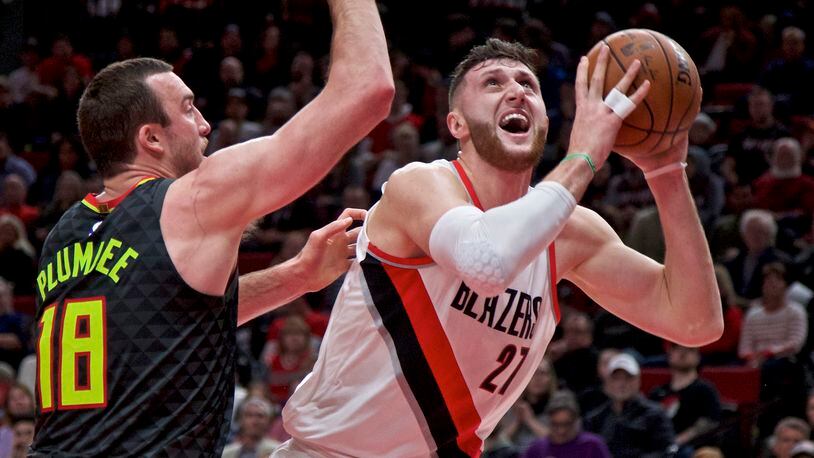 Portland Trail Blazers center Jusuf Nurkic, right, shoots over Atlanta Hawks center Miles Plumlee during the first half of an NBA basketball game in Portland, Ore., Friday, Jan. 5, 2018. (AP Photo/Craig Mitchelldyer)