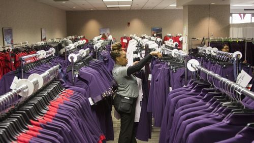 Carolyn Brown, a Delta Airlines uniform fitter, sorts through clothing racks to find the right sizes for employees during the uniform fitting for Delta employees at Hartsfield-Jackson Atlanta International Airport in Atlanta, Georgia, on Wednesday, February 7, 2018. (REANN HUBER/REANN.HUBER@AJC.COM)