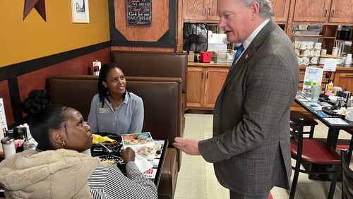 U.S. Rep. Mike Collins, R-Jackson, chats with diners at Pot Luck Cafe in Monroe before sitting down for lunch with members of his staff.