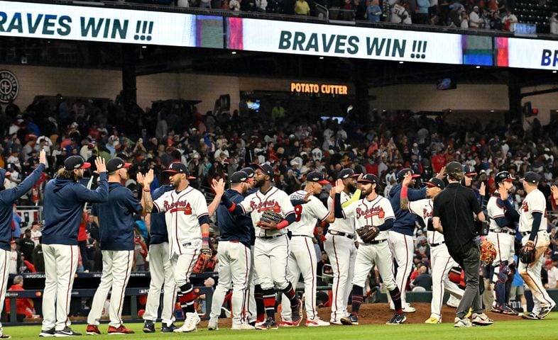 Atlanta Braves players celebrate a 3-0 win over the Philadelphia Phillies during the ninth inning of game two of the National League Division Series at Truist Park in Atlanta on Wednesday, October 12, 2022. (Hyosub Shin / Hyosub.Shin@ajc.com)