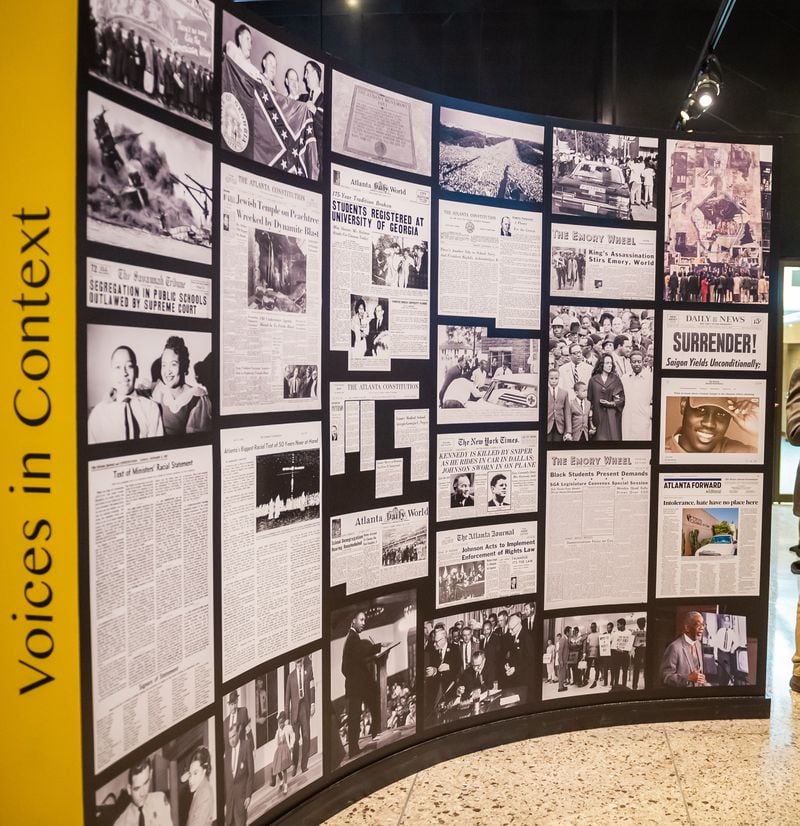 The “Voices in Context” wall features newspaper headlines and photographs of pivotal racial turning points in 20th century America.