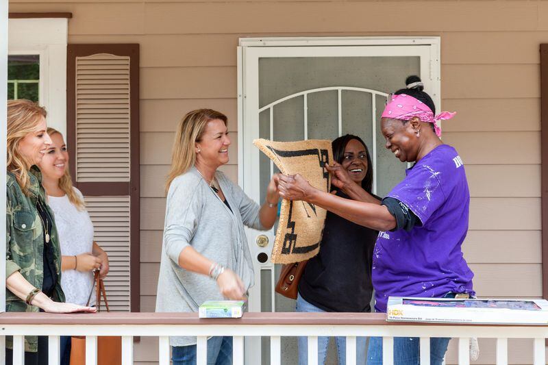 Volunteers congratulate Jamilah Najeeullah, who recently became a homeowner for the the first time, thanks to Atlanta Habitat for Humanity. “I’m so grateful,” she said recently. CONTRIBUTED