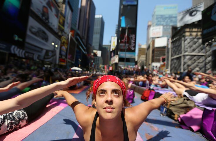 Enthusiasts perform yoga in Times Square to mark summer solstice, June 21, 2013