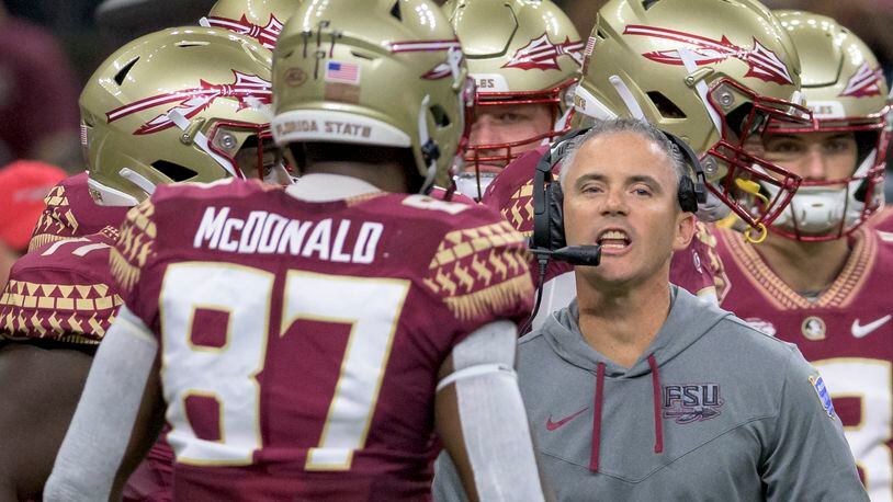 Florida State head coach Mike Norvell talks to his players during the first half of an NCAA football game against LSU on Saturday, Sept. 4, 2022, in New Orleans. (AP Photo/Matthew Hinton)