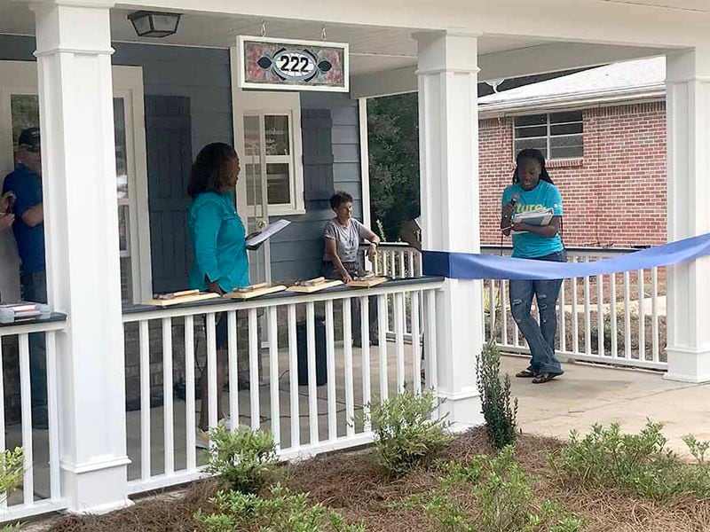 Shaquanna Denson (right) thanks Habitat for Humanity and others who helped build a new home for her and her son. (Photo: Alexis Stevens/Alexis.Stevens@ajc.com)