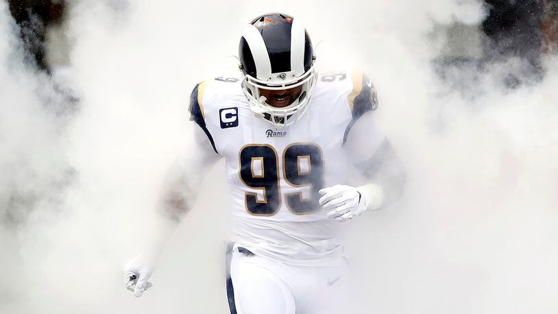 Rams'  Aaron Donald runs onto the field as he is introduced before the game against the New Orleans Saints Sept. 15, 2019, at Los Angeles Memorial Coliseum in Los Angeles.