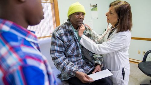 Dr. Gulshan Harjee, right, examines Simeon Gahungu, who is from Burundi and who came to the U.S. as a refugee form Tanzania, at the Clarkston Community Health Center on Dec. 17, 2017. Harjee co-founded the clinic to serve refugees, immigrants and other uninsured people. At left is Gahungu's son Matias Manirakiza, 17. BITA HONARVAR/SPECIAL