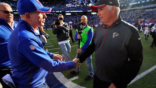 EAST RUTHERFORD, NJ - OCTOBER 05: Head coach Tom Coughlin of the New York Giants talks with head coach Mike Smith of the Atlanta Falcons after their game at MetLife Stadium on October 5, 2014 in East Rutherford, New Jersey. The New York Giants defeated the Atlanta Falcons 30 - 20. (Photo by Alex Goodlett/Getty Images) Tom Coughlin's and Mike Smith's teams are going in different directions in the NFC. (Alex Goodlett/Getty Images)