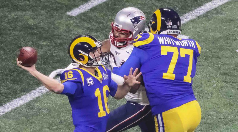 Rams quarterback Jared Goff (16) releases a pass as Patriots defensive end Adrian Clayborn (94) closes in despite Rams offensive tackle Andrew Whitworth's best efforts to block him during third quarter of Super Bowl LIII Sunday, Feb. 3, 2019, at Mercedes-Benz Stadium in Atlanta. (John Spink / AJC)