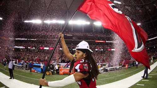 Jalen Collins runs through the field with a Falcons flag after defeating the Green Bay Packers in the NFC Championship Game at the Georgia Dome on January 22, 2017 in Atlanta, Georgia. The Falcons defeated the Packers 44-21. (Tom Pennington/Getty Images)