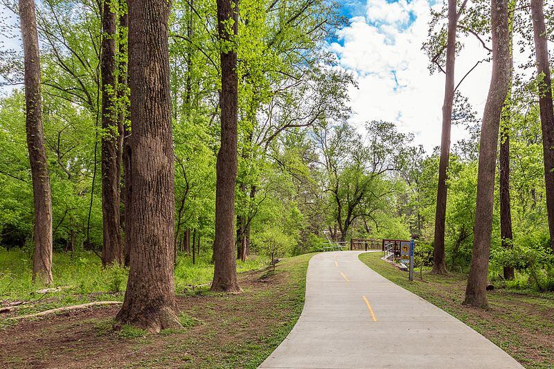 The Atlanta BeltLine Northside Trail runs under the canopy of towering trees at Tanyard Creek Park.
